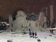 People walk next to a mosque destroyed by an earthquake in Malatya, Turkey, Monday, Feb. 6, 2023. A powerful quake has knocked down multiple buildings in southeast Turkey and Syria and many casualties are feared. (DIA images via AP)