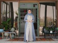 Omani artist Alia Al Farsi stands at door. Image by Burair Alkishri