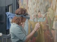 Conservator works on altarpiece