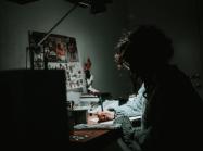 a person sits at a desk with a lamp