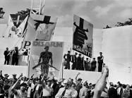 DAVID SEYMOUR black and white photograph of a crowd of people with their fists raised in the air
