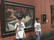 Just Stop Oil activists standing by the Rokeby Venus after hitting the protective glass with safety hammers.