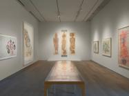 photo of a museum gallery with large works on art on white walls