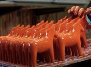 red sculpture horses being painted