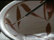 brush gently paints decoration inside of bowl