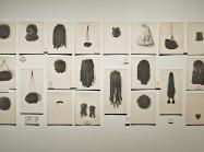 Lorna Simpson art installation of 20 images of wigs hung on a wall