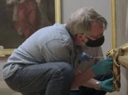 men working on art in masks