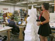 artist works on sculpture in studio