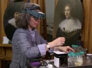 Conservator at work on painting