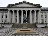 neoclassical building with columns and statue in front