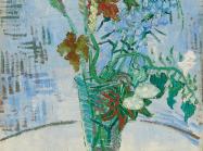 Van Gogh still life of flowers in a glass vase on a table top with a blue cross-hatched wall behind