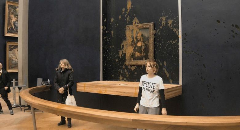 Protesters from the group Riposte Alimentaire after splashing pumpkin soup on the Mona Lisa.