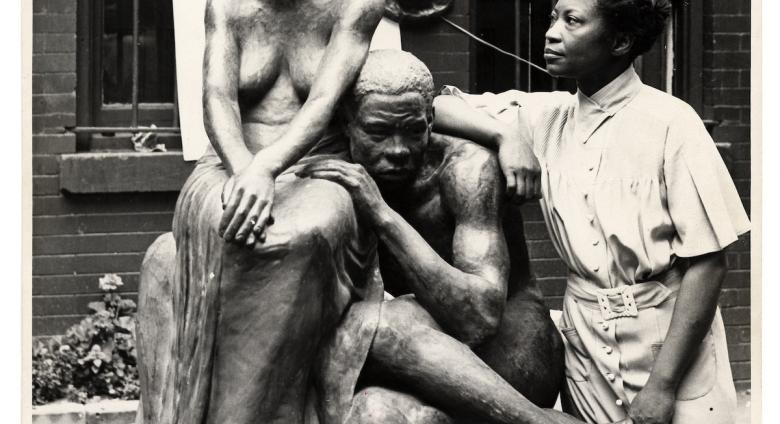 Augusta Savage posing with her sculpture Realization, created as part of the Works Progress Administration's Federal Art Project. Photo by Andrew Herman, circa 1938. Wikimedia Commons