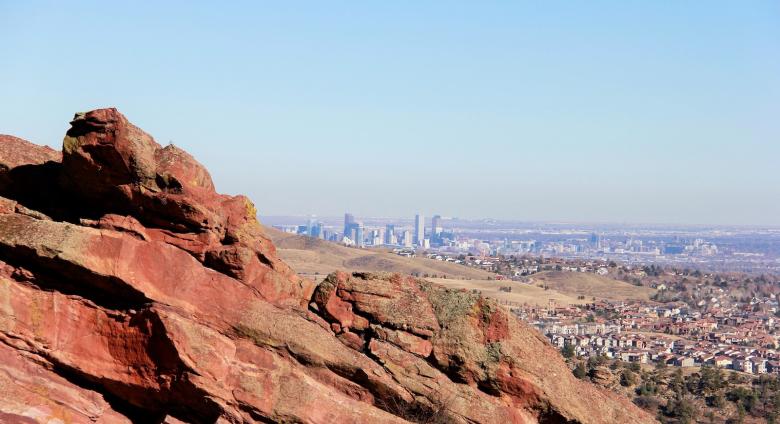 A view of denver over red rocks