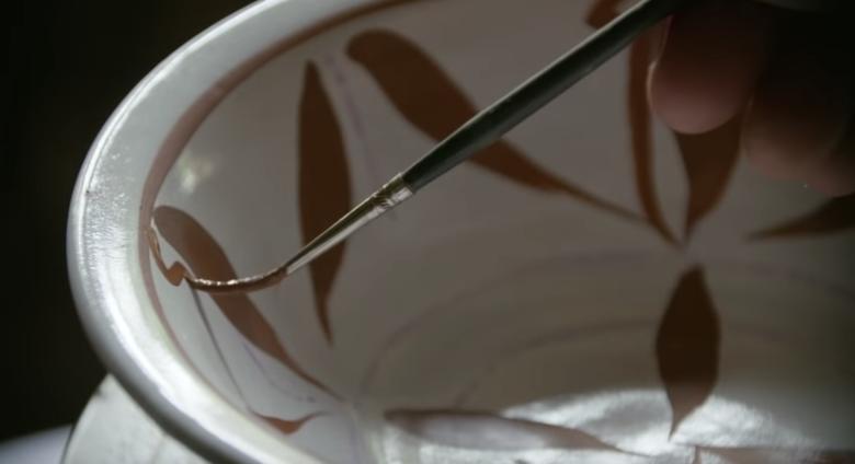 brush gently paints decoration inside of bowl