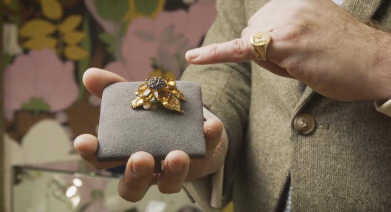 An expert shows a piece of jewelry