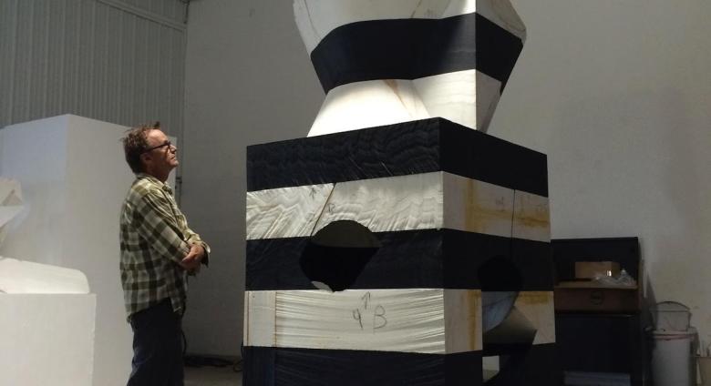 Portrait of Mel Kendrick with his artwork