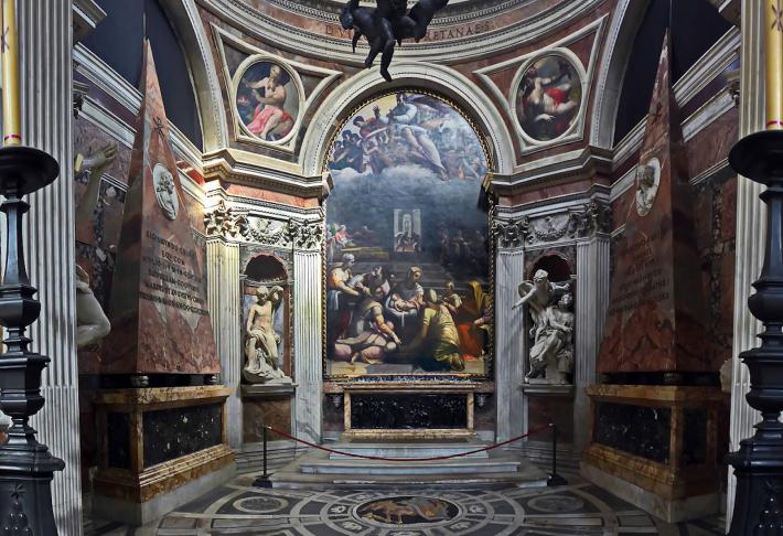 a look into the Chigi Chapel, small yet ornate with white marble, dark green, pink and gold details.